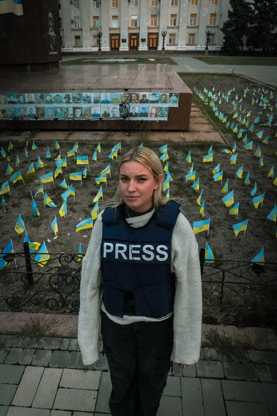 Kelsey Kimberlin stands near a memorial to fallen soldiers