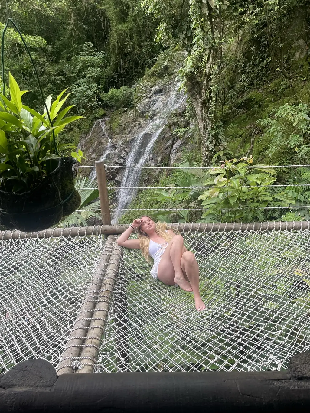 Kelsie Kimberlin lies on a balcony near a waterfall