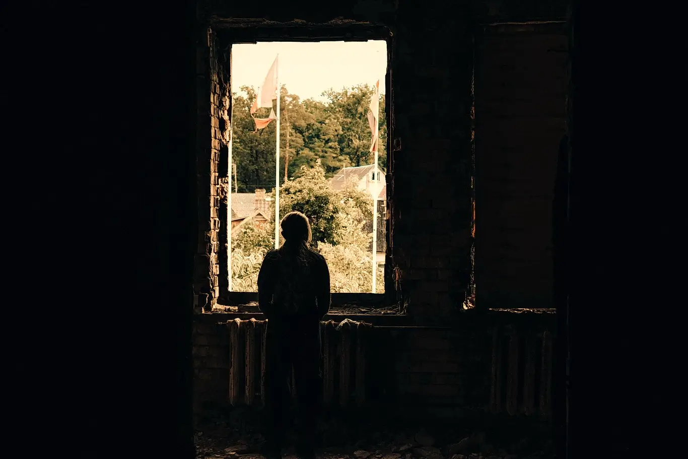 Kelsie Kimberlin looks out the window of a destroyed house