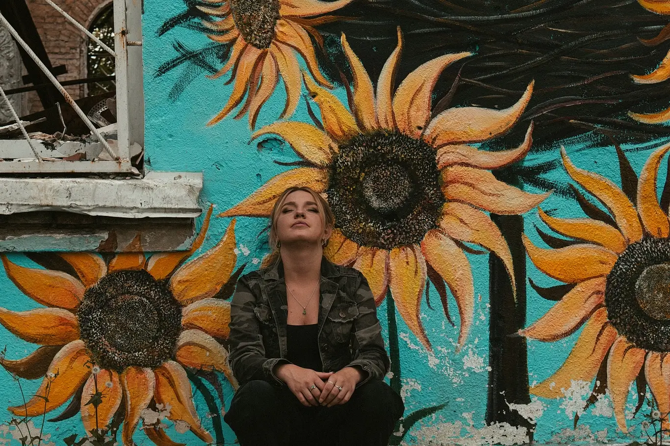 Kelsie Kimberlin sits against a wall next to the destroyed cultural center Kelsie Kimberlin sits against a wall next to the destroyed cultural center