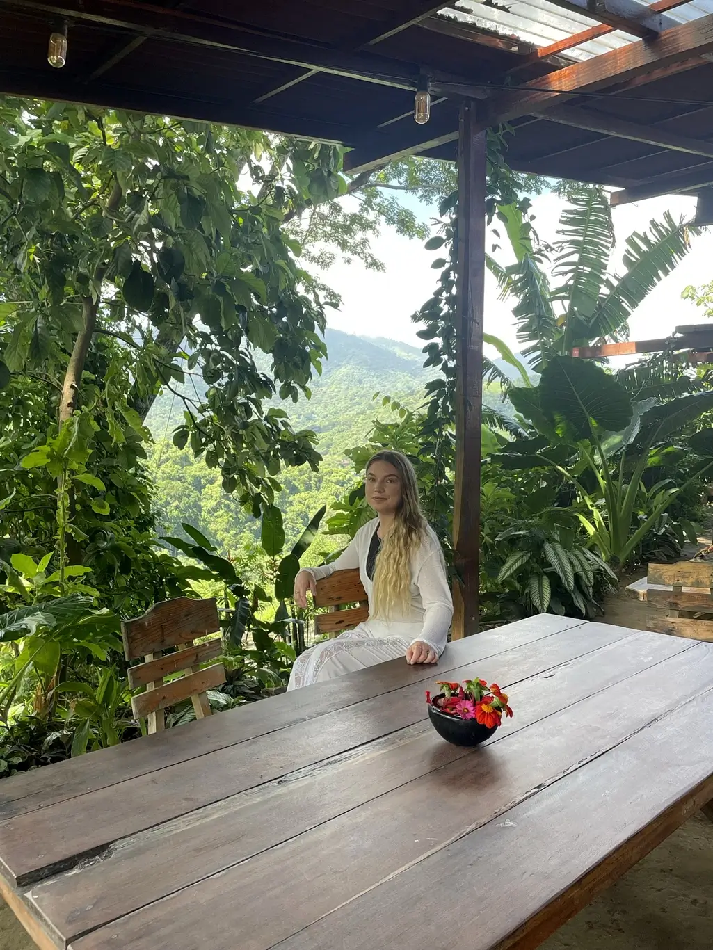 Kelsie Kimberlin sits at a table near the mountains