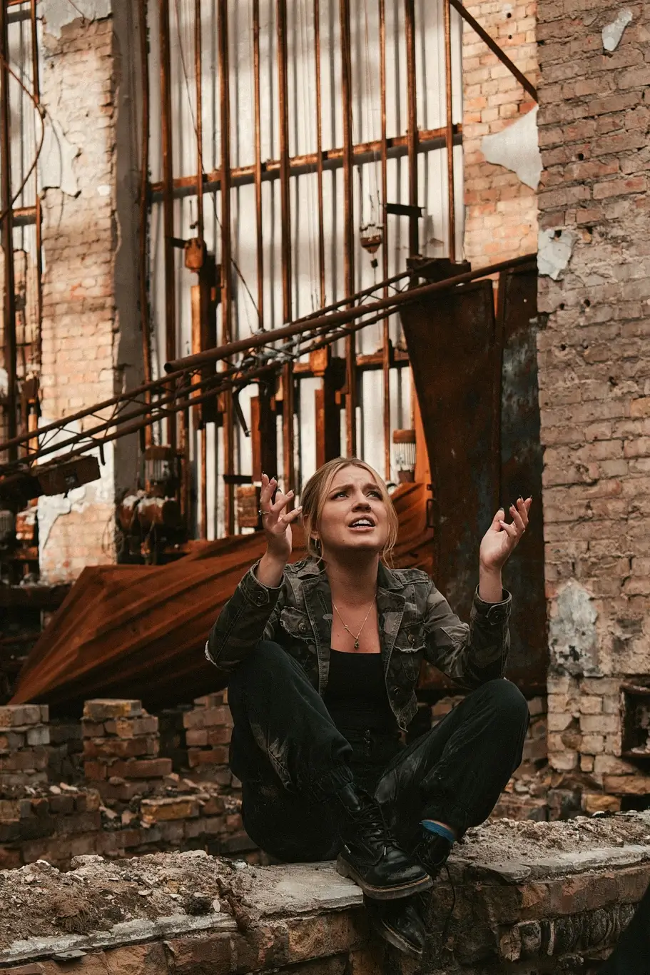 Kelsie Kimberlin sits near the ruins of the cultural center and cries Kelsie Kimberlin sits near the ruins of the cultural center and cries