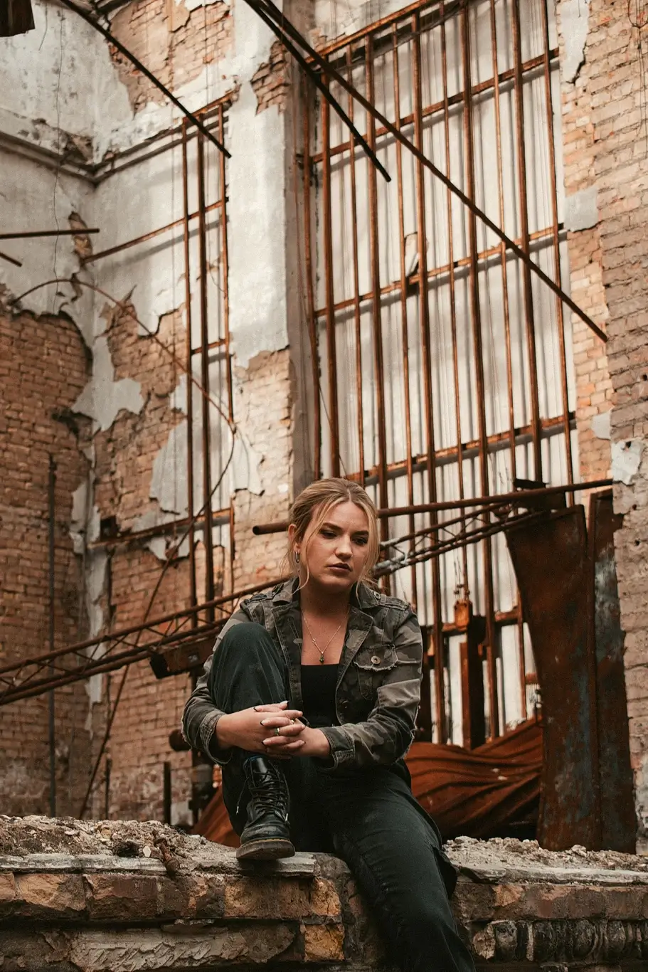 Kelsie Kimberlin sits near the ruins of the cultural center Kelsie Kimberlin sits near the ruins of the cultural center