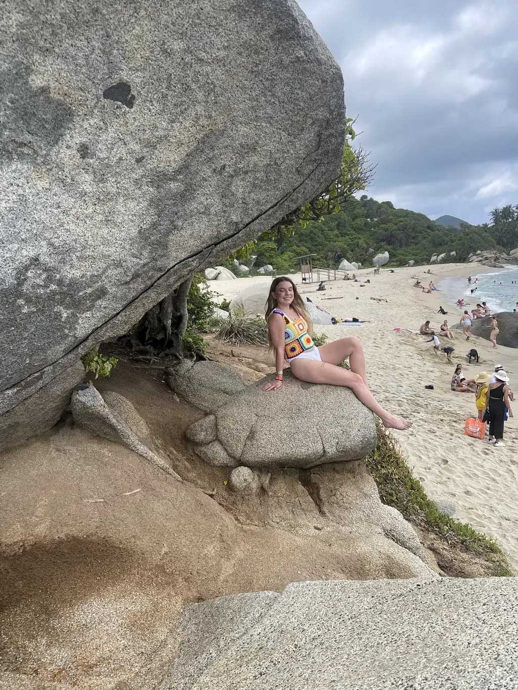 Kelsie Kimberlin sits on a rock in a knitted T-shirt