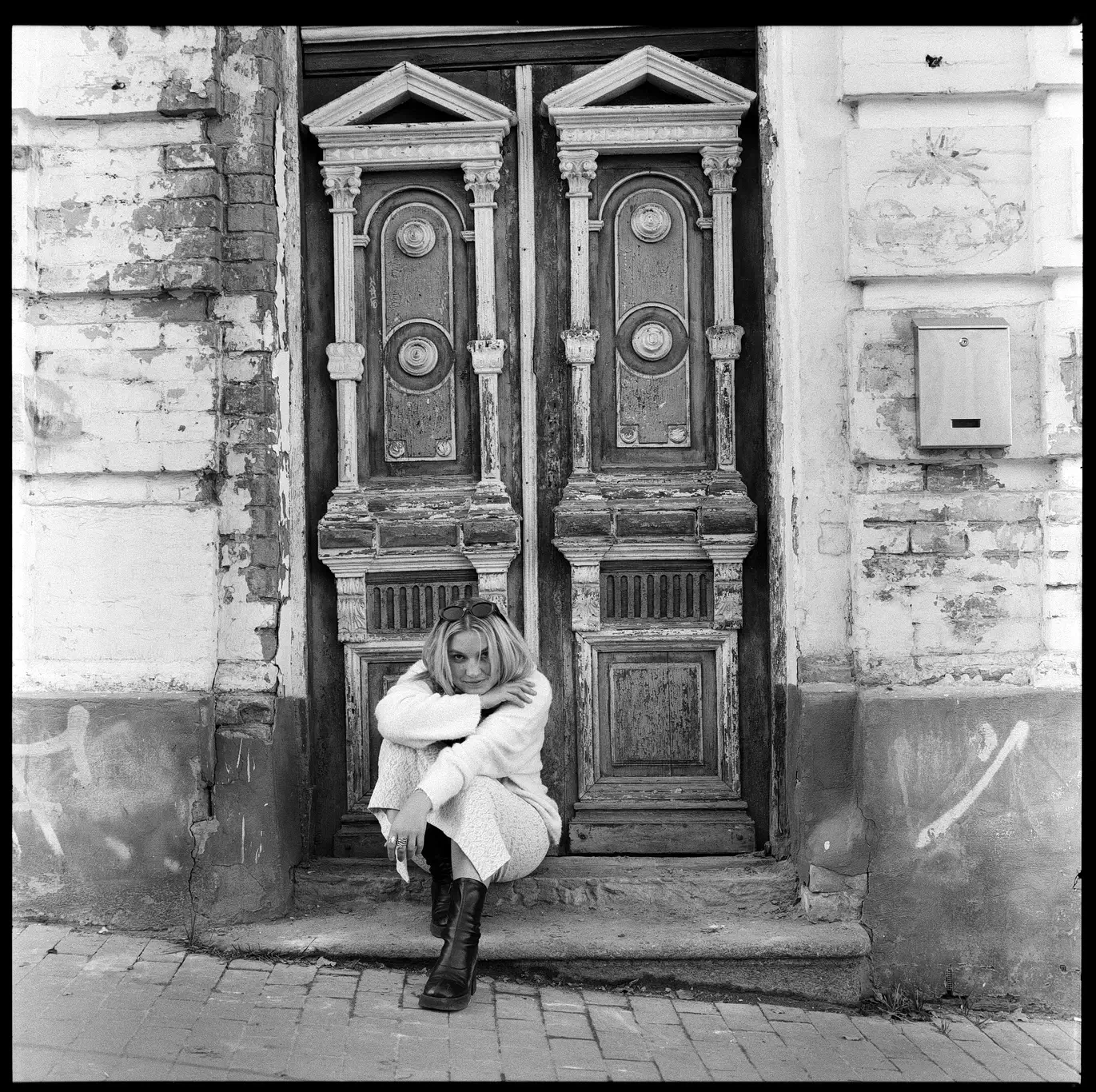 Kelsie Kimberlin sits on the steps of an antique doorway