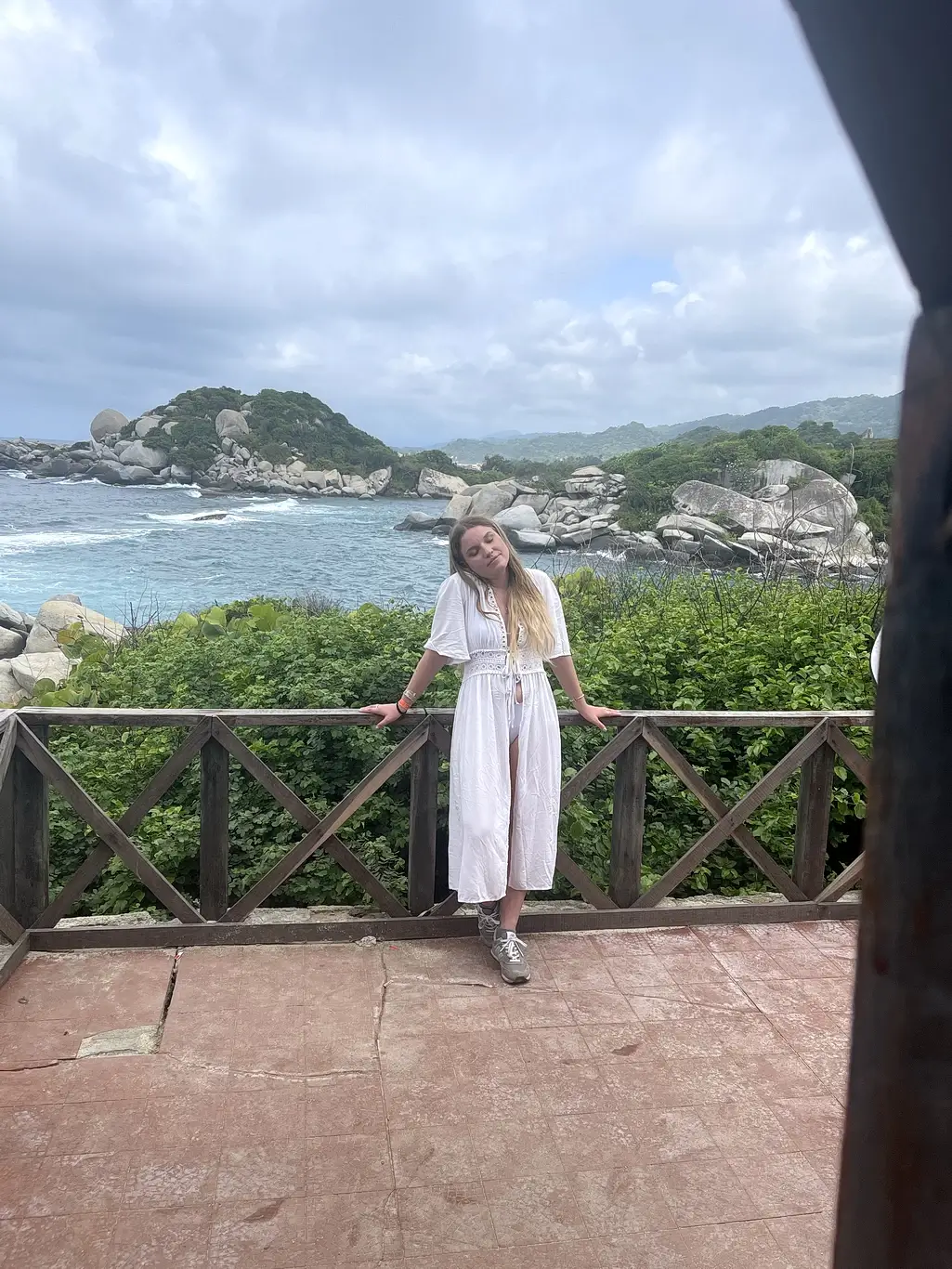 Kelsie Kimberlin stands against a backdrop of sea and rocks