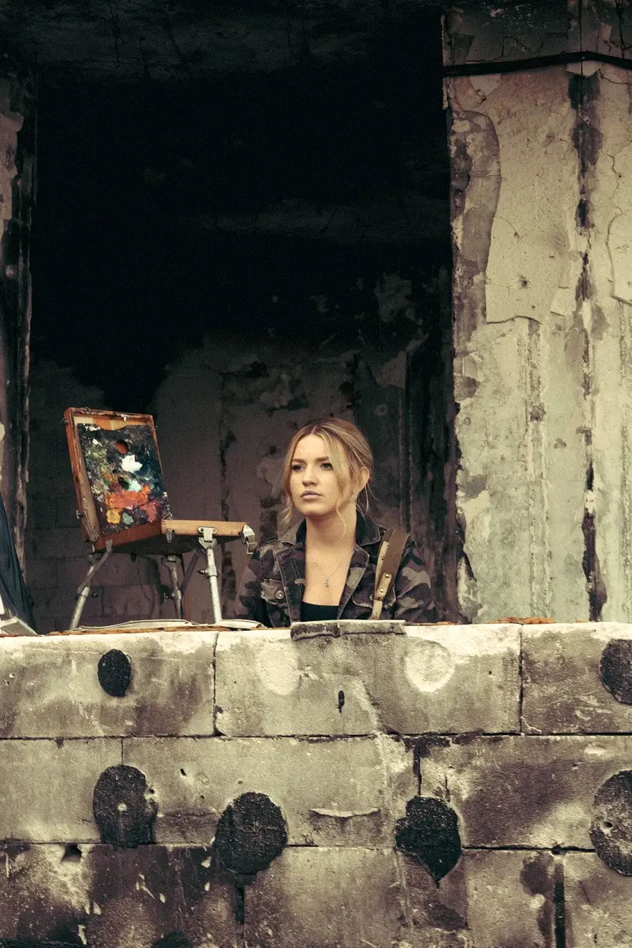 Kelsie Kimberlin stands in a destroyed house