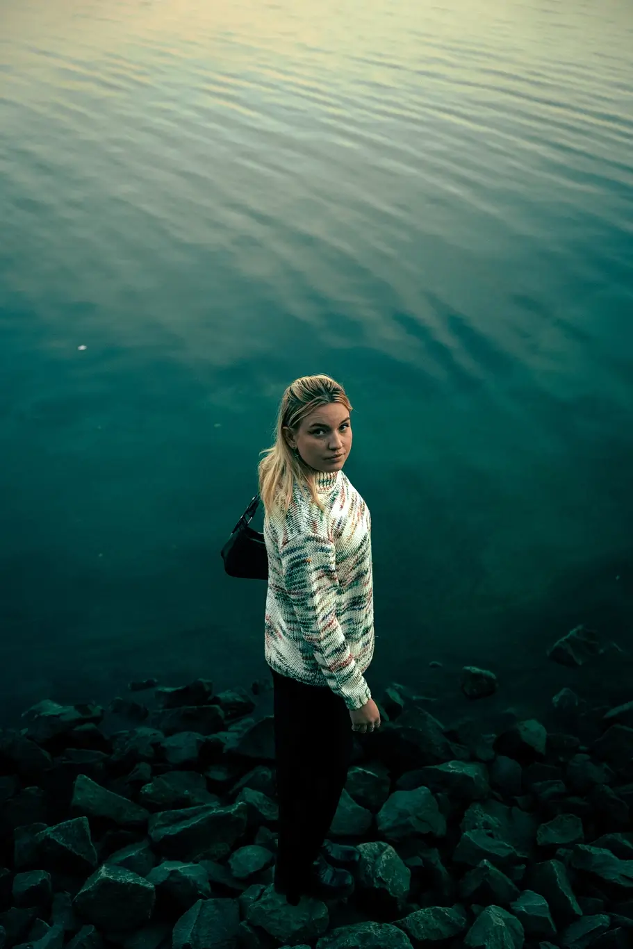 Kelsie Kimberlin stands on rocks near the water