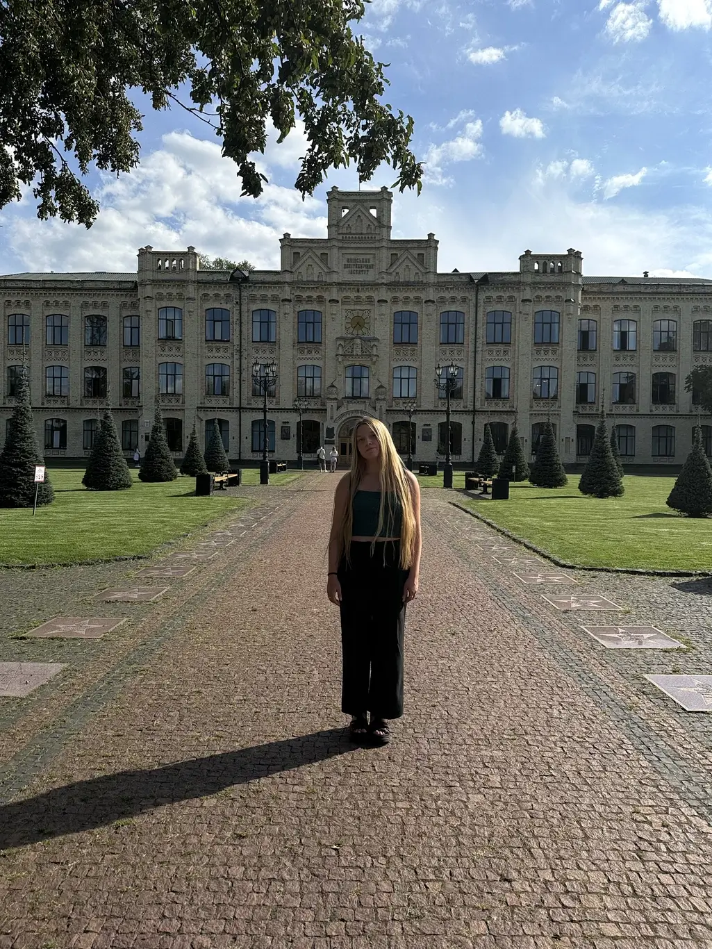 Kelsie Kimberlin stands on the alley of the Kyiv Polytechnic Institute