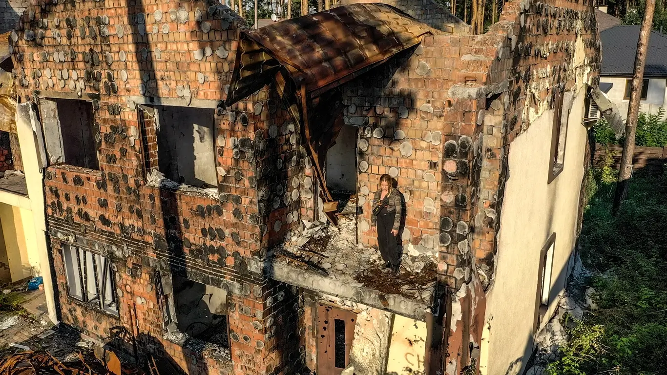 Kelsie Kimberlin stands on the balcony of a destroyed building