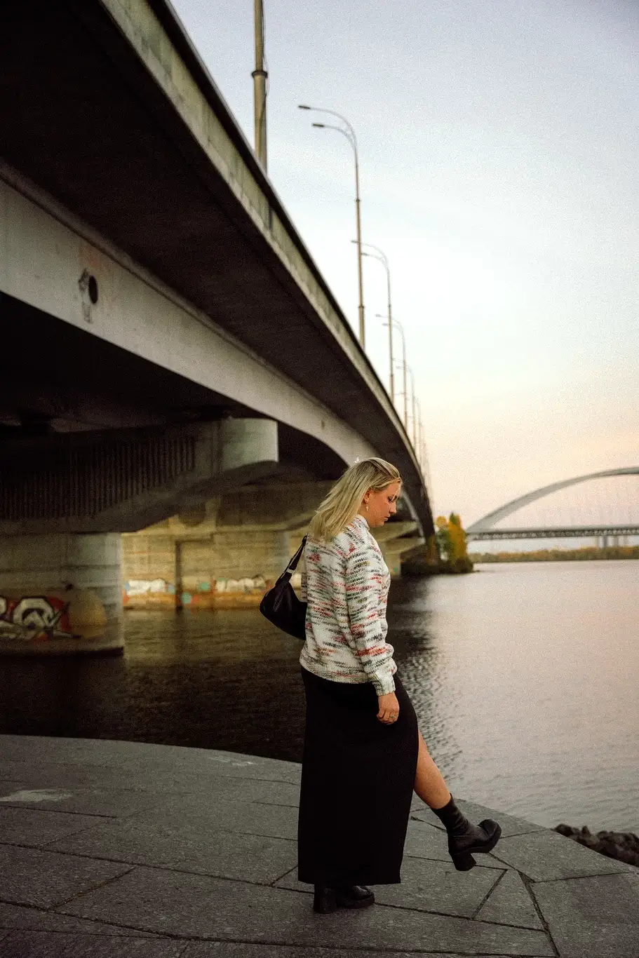 Kelsie Kimberlin stands on the embankment near the bridge