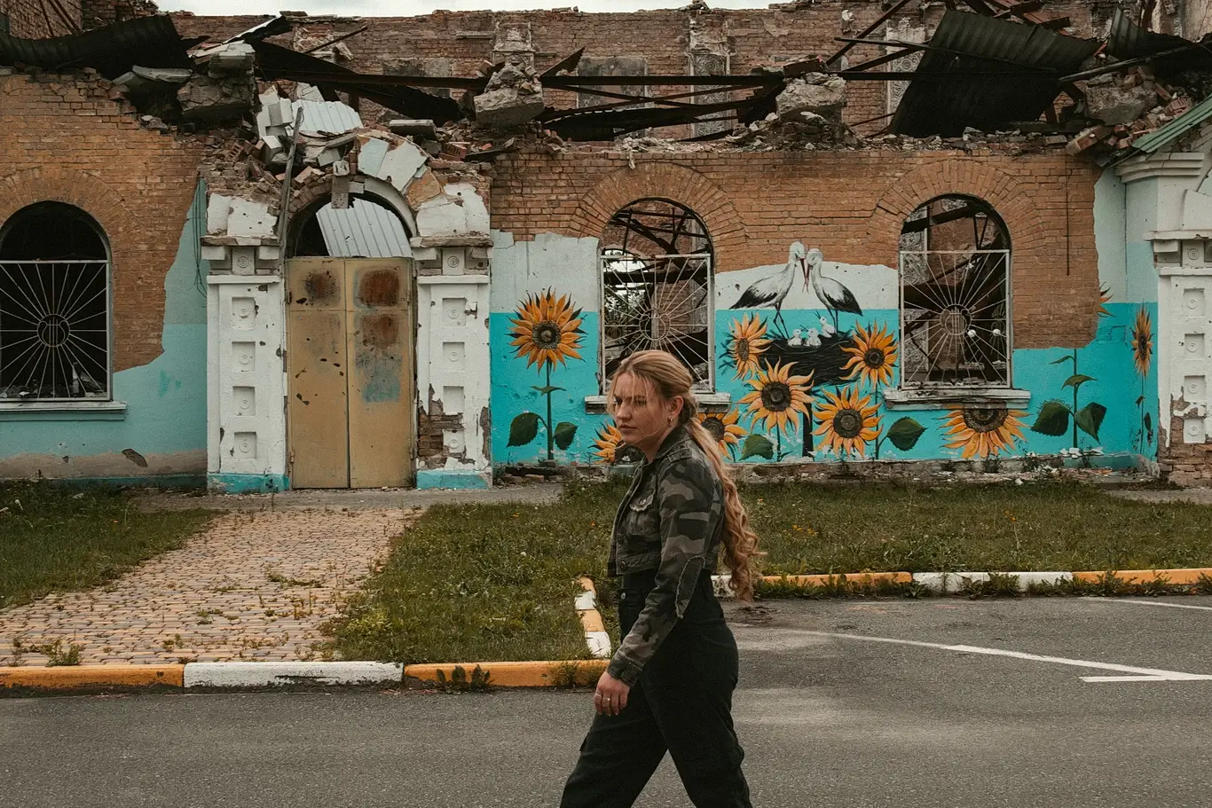 Kelsie Kimberlin walks down the street next to the destroyed cultural center Kelsie Kimberlin walks down the street next to the destroyed cultural center